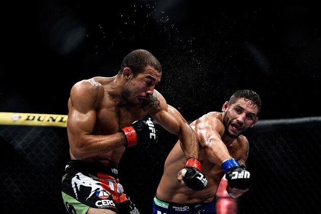 RIO DE JANEIRO, BRAZIL - OCTOBER 25: Chad Mendes of the United States punches Jose Aldo of Brazil in their featherweight championship bout during the UFC 179 event at Maracanazinho on October 25, 2014 in Rio de Janeiro, Brazil. (Photo by Buda Mendes/Getty Images)