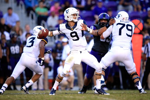 FORT WORTH, TX - NOVEMBER 02:  Quarterback Clint Trickett #9 of the West Virginia Mountaineers passes during the game against the TCU Horned Frogs at Amon G. Carter Stadium on November 2, 2013 in Fort Worth, Texas.  (Photo by Jamie Squire/Getty Images)