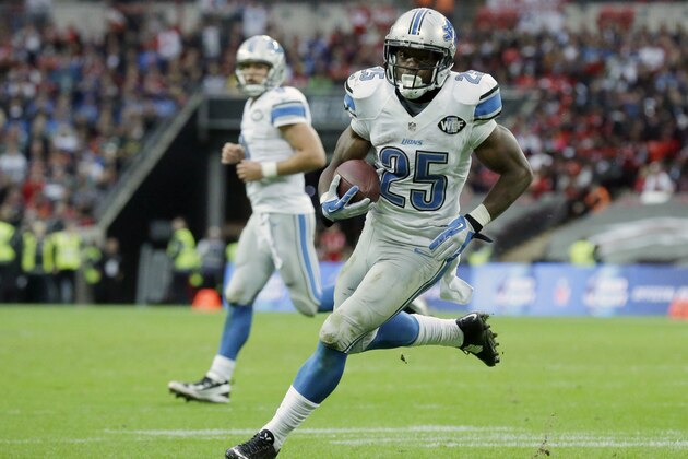 Detroit Lions running back Theo Riddick (25) runs to the end zone for a touchdown after receiving a pass thrown by quarterback Matthew Stafford (9) in the second half of the NFL football game against the Atlanta Falcons at Wembley Stadium, London, Sunday, Oct. 26, 2014.  (AP Photo/Matt Dunham)