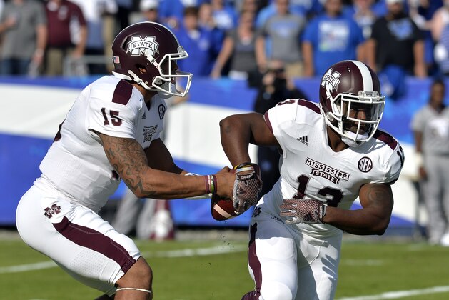 Mississippi State's Dak Prescott, left, fakes a handoff to Josh Robinson during the second quarter of an NCAA college football game at Commonwealth Stadium in Lexington, Ky., Saturday, Oct. 25, 2014. (AP Photo/Timothy D. Easley)