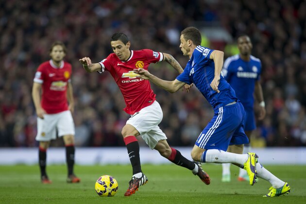 Manchester United's Angel Di Maria, center, fights for the ball against Chelsea's Nemanja Matic during their English Premier League soccer match between Manchester United and Chelsea at Old Trafford Stadium, Manchester, England, Sunday, Oct. 26, 2014. (AP Photo/Jon Super)