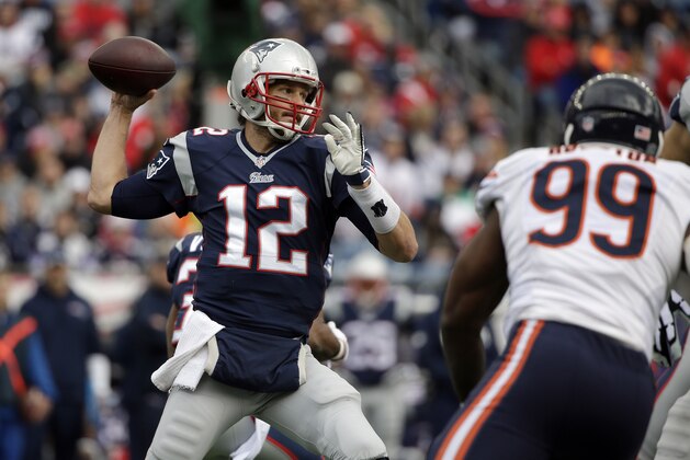 New England Patriots quarterback Tom Brady (12) passes over Chicago Bears defensive end Lamarr Houston (99) in the first half of an NFL football game on Sunday, Oct. 26, 2014, in Foxborough, Mass. (AP Photo/Steven Senne)