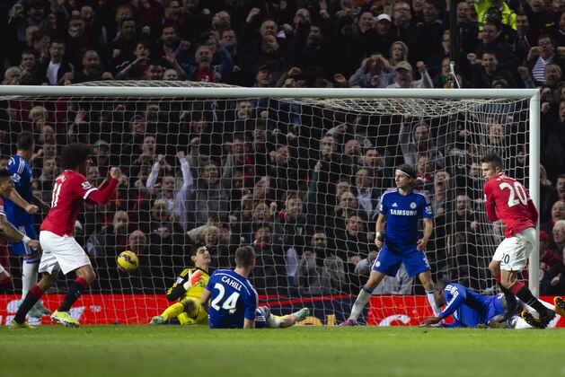 Manchester United's Robin van Persie, right, reacts after scoring against Chelsea during the English Premier League soccer match between Manchester United and Chelsea at Old Trafford Stadium, Manchester, England, Sunday Oct. 26, 2014. (AP Photo/Jon Super)