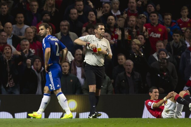Chelsea's Chelsea's Branislav Ivanovic, left, is sent off by referee Phil Dowd after a foul on Manchester United's Angel Di Maria, right, during their English Premier League soccer match between Manchester United and Chelsea at Old Trafford Stadium, Manchester, England, Sunday Oct. 26, 2014. (AP Photo/Jon Super)