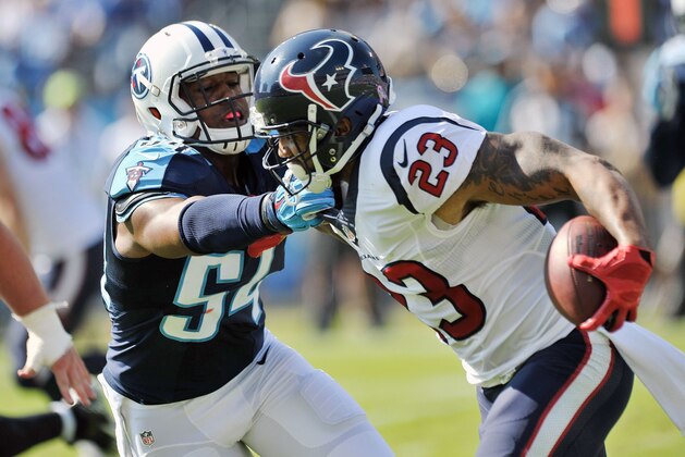 Oct 26, 2014; Nashville, TN, USA; Houston Texans running back Arian Foster (23) rushes against Tennessee Titans inside linebacker Avery Williamson (54) during the first half at LP Field. Mandatory Credit: Jim Brown-USA TODAY Sports