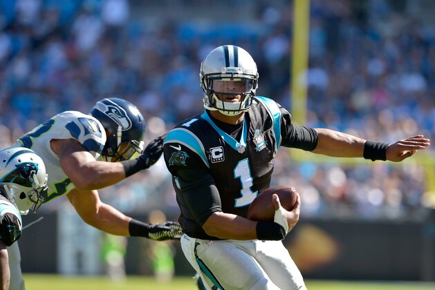 CHARLOTTE, NC - OCTOBER 26:  Michael Bennett #72 of the Seattle Seahawks pressure Cam Newton #1 of the Carolina Panthers during their game at Bank of America Stadium on October 26, 2014 in Charlotte, North Carolina.  (Photo by Grant Halverson/Getty Images)