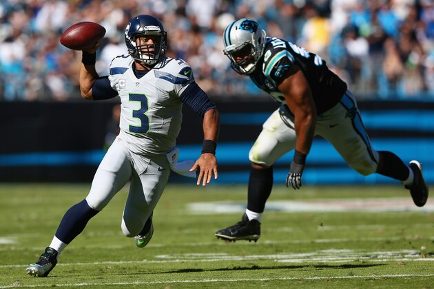 CHARLOTTE, NC - OCTOBER 26:  Russell Wilson #3 of the Seattle Seahawks scrambles from the Carolina Panthers defense in the 3rd quarter during the game at Bank of America Stadium on October 26, 2014 in Charlotte, North Carolina.  (Photo by Streeter Lecka/Getty Images)