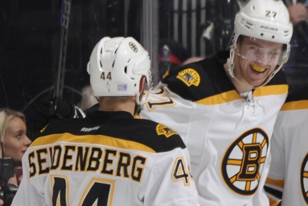 TORONTO, ON - OCTOBER 25:  Dennis Seidenberg #44, Dougie Hamilton #27 Reilly Smith #18 and Patrice Bergeron #37 of the Boston Bruins celebrate a third period goal during NHL game action against the Toronto Maple Leafs October 25, 2014 at the Air Canada Centre in Toronto, Ontario, Canada. (Photo by Graig Abel/NHLI via Getty Images)