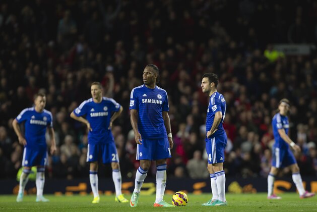 Chelsea players including Didier Drogba, center, wait for play to restart after Robin van Persie's equalising goal during their English Premier League soccer match against Manchester United at Old Trafford Stadium, Manchester, England, Sunday Oct. 26, 2014. (AP Photo/Jon Super)