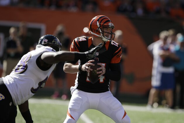 Baltimore Ravens outside linebacker Elvis Dumervil, left, pressures Cincinnati Bengals quarterback Andy Dalton during the first half of an NFL football game in Cincinnati, Sunday, Oct. 26, 2014. (AP Photo/Darron Cummings)