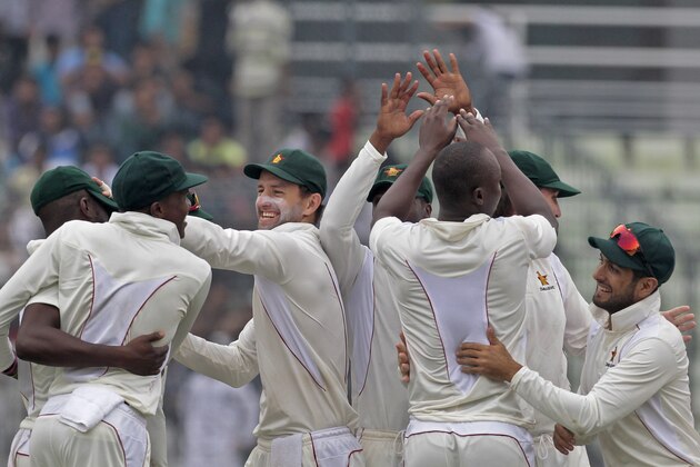 Zimbabwean players celebrate the dismissal of Bangladesh’s Shakib Al Hasan during the second day of the first cricket test match between them in Dhaka, Bangladesh, Sunday, Oct. 26, 2014. (AP Photo/A.M. Ahad)