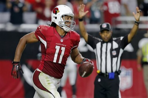 CORRECTS TO SECOND HALF NOT FIRST HALF - Arizona Cardinals wide receiver Larry Fitzgerald (11) scores a touchdown against the Philadelphia Eagles during the second half of an NFL football game, Sunday, Oct. 26, 2014, in Glendale, Ariz. (AP Photo/Rick Scuteri)