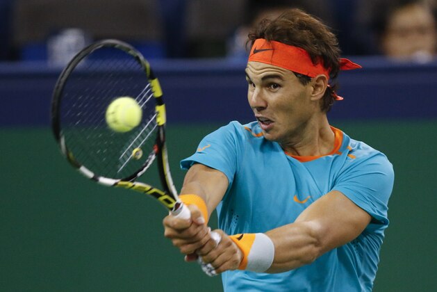 Rafael Nadal of Spain returns a shot to Feliciano Lopez of Spain during their men's singles second round match at the Shanghai Masters Tennis Tournament in Shanghai, China, Wednesday, Oct. 8, 2014.  (AP Photo/Vincent Thian)