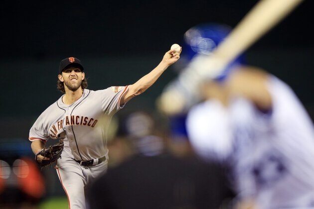 San Francisco Giants pitcher Madison Bumgarner throws during the first inning of Game 1 of baseball's World Series against the Kansas City Royals Tuesday, Oct. 21, 2014, in Kansas City, Mo. (AP Photo/Jamie Squire, Pool)