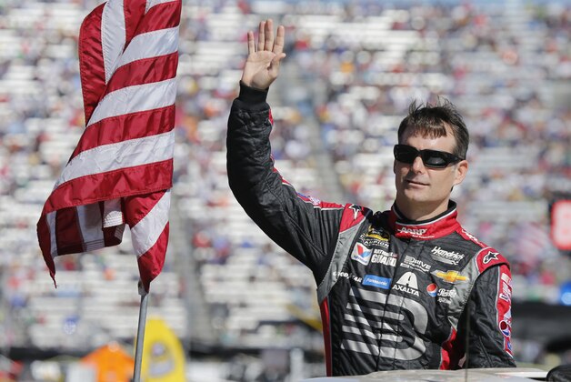 Jeff Gordon waves to the crowd during driver introductions for the NASCAR Sprint Cup Series auto race at Martinsville Speedway in Martinsville, Va., Sunday, Oct. 26, 2014.(AP Photo/Steve Helber)