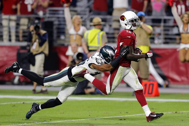 Arizona Cardinals wide receiver John Brown (12) scores a touchdown as Philadelphia Eagles cornerback Cary Williams (26) defends during the second half of an NFL football game, Sunday, Oct. 26, 2014, in Glendale, Ariz. (AP Photo/Rick Scuteri)