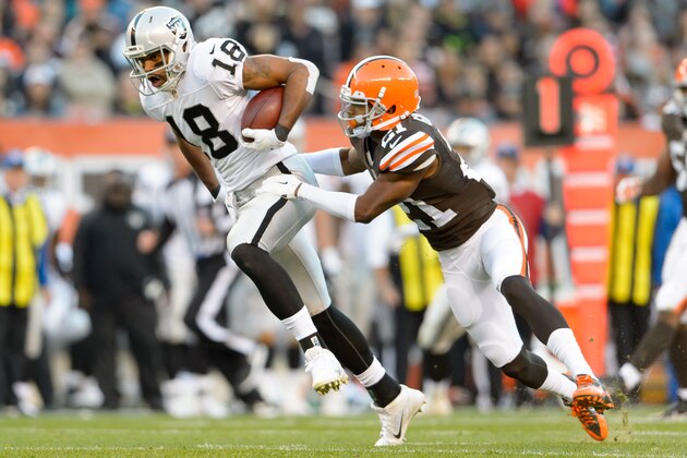 CLEVELAND, OH - OCTOBER 26: Wide receiver Andre Holmes #18 of the Oakland Raiders makes a catch while under pressure from cornerback Justin Gilbert #21 of the Cleveland Browns during the first half at FirstEnergy Stadium in Cleveland, Ohio. (Photo by Jason Miller/Getty Images)