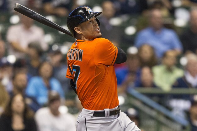 Miami Marlins' Giancarlo Stanton follows through on a solo home run of off Milwaukee Brewers' Yovani Gallardo during the third inning of a baseball game Monday, Sept. 8, 2014, in Milwaukee. (AP Photo/Tom Lynn)