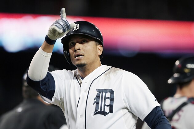 Detroit Tigers designated hitter Victor Martinez points to the stands after his solo home run during the fourth inning of a baseball game against the Cleveland Indians in Detroit, Saturday, Sept. 13, 2014. (AP Photo/Carlos Osorio)