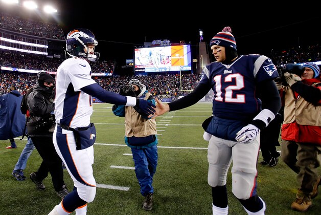 FOXBORO, MA - NOVEMBER 24: Quarterback Peyton Manning #18 of the Denver Broncos and quarterback Tom Brady #12 of the New England Patriots shake hands after the New England Patriots defeated the Denver Broncos 34-31 in overtime at Gillette Stadium on November 24, 2013 in Foxboro, Massachusetts.  (Photo by Jim Rogash/Getty Images)
