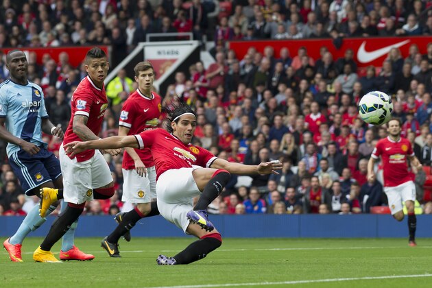 Manchester United's Radamel Falcao Garcia,  foreground, narrowly fail to score during his team's English Premier League soccer match against West Ham United at Old Trafford Stadium, Manchester, England, Saturday Sept. 27, 2014. (AP Photo/Jon Super)