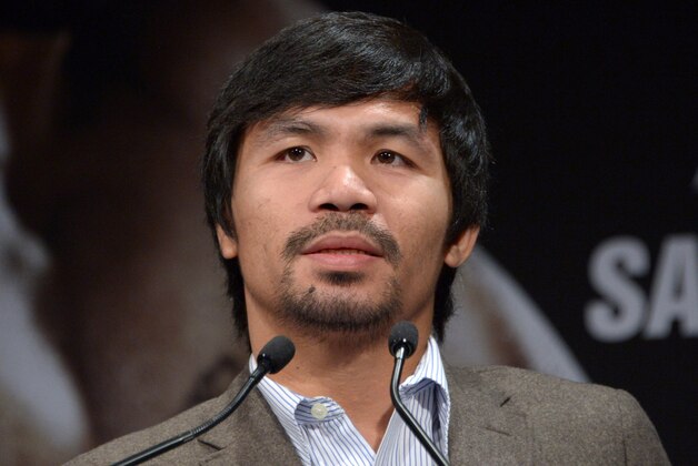 Sep 3, 2014; Los Angeles, CA, USA; Manny Pacquiao poses at press conference at Hyatt Regency Century Plaza Hotel in advance of World Welterweight Championship bout against Chris Algieri (not pictured) on Nov. 22, 2014. Mandatory Credit: Kirby Lee-USA TODAY Sports