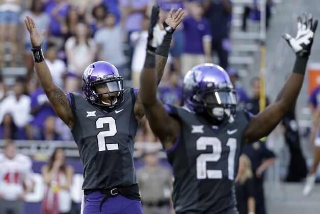 TCU quarterback Trevone Boykin (2) and running back Kyle Hicks (21) celebrate after a touchdown against Texas Tech in the second half of an NCAA college football game, Saturday, Oct. 25, 2014, in Fort Worth, Texas. TCU won 82-27. (AP Photo/Tony Gutierrez)