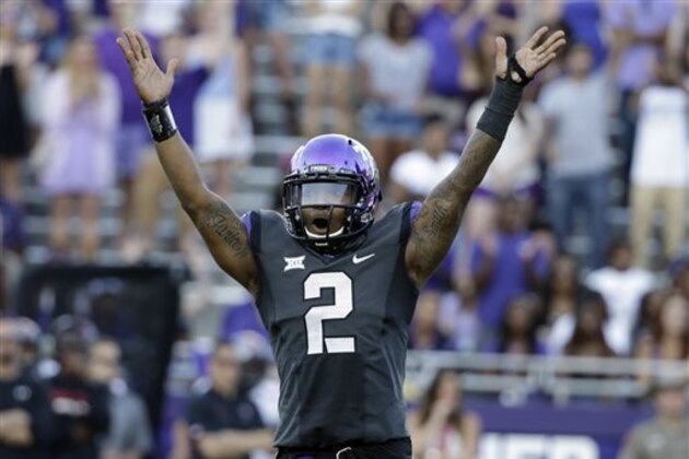 TCU quarterback Trevone Boykin (2) celebrates a score against Texas Tech in the second half of an NCAA college football game, Saturday, Oct. 25, 2014, in Fort Worth, Texas. Boykin threw a school-record seven touchdown passes and No.10 TCU showcased a new fast-paced offense by scoring the most points in its history in an 82-27 rout of Texas Tech on Saturday. (AP Photo/Tony Gutierrez)