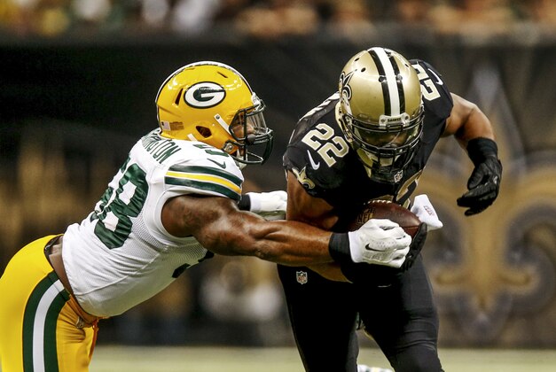 Oct 26, 2014; New Orleans, LA, USA; New Orleans Saints running back Mark Ingram (22) breaks a tackle by Green Bay Packers inside linebacker Sam Barrington (58) during the second quarter of a game at the Mercedes-Benz Superdome. Mandatory Credit: Derick E. Hingle-USA TODAY Sports