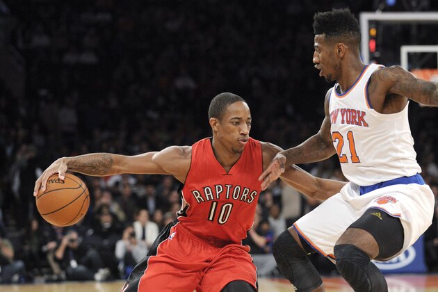 Toronto Raptors guard DeMar DeRozan, left, drives to the basket as New York Knicks guar Iman Shumpert defends during the first quarter of an NBA basketball game Monday, Oct. 13, 2014, at Madison Square Garden in New York. (AP Photo/Bill Kostroun)