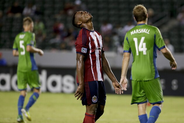 Chivas USA midfielder Carlos Alvarez, middle, reacts after missing a shot as Seattle Sounders midfielder Andy Rose, left, and Chad Marshall walk away during the second half of an MLS soccer match Wednesday, Sept. 3, 2014, in Carson, Calif. (AP Photo/Chris Carlson)