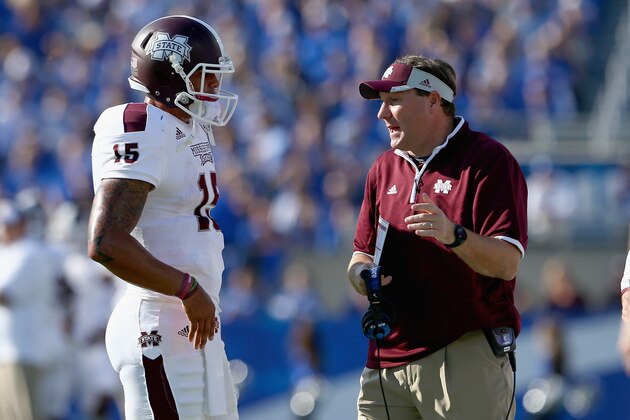 LEXINGTON, KY - OCTOBER 25:  Dak Prescott #15 of the Mississippi State Bulldogs runs talks with head coach Dan Mullens during the game against the Kentucky Wildcats at Commonwealth Stadium on October 25, 2014 in Lexington, Kentucky.  (Photo by Andy Lyons/Getty Images)