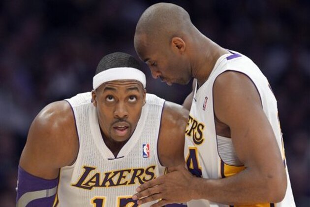 Los Angeles Lakers guard Kobe Bryant, right, chats with center Dwight Howard during the first half of the Lakers' NBA basketball game against the Cleveland Cavaliers, Sunday, Jan. 13, 2013, in Los Angeles. (AP Photo/Mark J. Terrill)