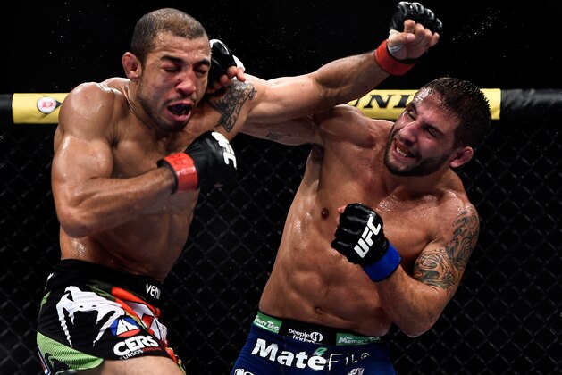 RIO DE JANEIRO, BRAZIL - OCTOBER 25: Chad Mendes of the United States punches Jose Aldo of Brazil in their featherweight championship bout during the UFC 179 event at Maracanazinho on October 25, 2014 in Rio de Janeiro, Brazil. (Photo by Buda Mendes/Getty Images)