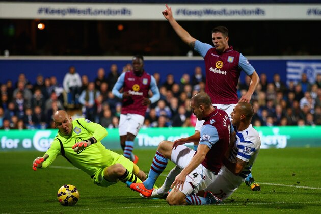 LONDON, ENGLAND - OCTOBER 27:  Ron Vlaar of Aston Villa slides in to tackle Bobby Zamora of QPR during the Barclays Premier League match between Queens Park Rangers and Aston Villa at Loftus Road on October 27, 2014 in London, England.  (Photo by Ian Walton/Getty Images)