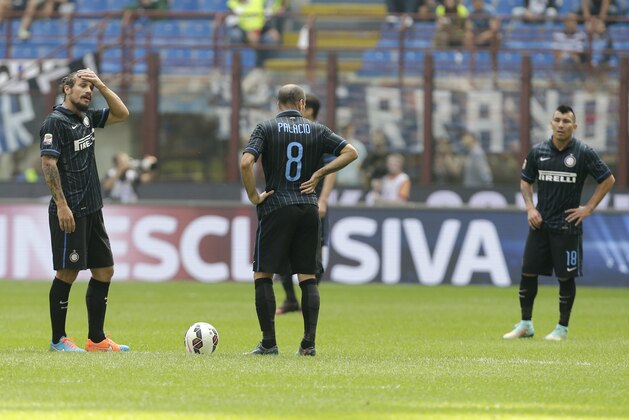 From left, Inter Milan's Pablo Osvaldo, Rodrigo Palacio, Gary Medel react after Cagliari's Albin Ekdal scored during the Serie A soccer match between Inter Milan and Cagliari at the San Siro stadium in Milan, Italy, Sunday, Sept. 28, 2014. (AP Photo/Antonio Calanni)