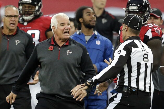 Atlanta Falcons head coach Mike Smith argues with an official in the second half of the NFL football game against the Detroit Lions at Wembley Stadium, London, Sunday, Oct. 26, 2014. The Lions won 22-21.  (AP Photo/Matt Dunham)