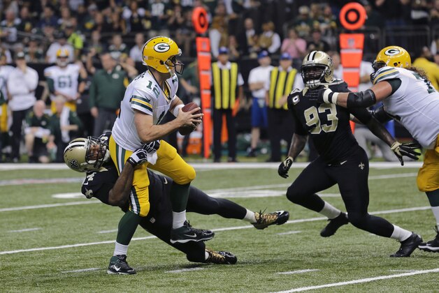 Green Bay Packers quarterback Aaron Rodgers (12) is sacked byNew Orleans Saints defensive end Cameron Jordan (94) in the first half of an NFL football game in New Orleans, Sunday, Oct. 26, 2014. (AP Photo/Bill Haber)