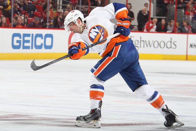 RALEIGH, NC - OCTOBER 10: Johnny Boychuk #55 of the New York Islanders fires the a shot which is defelcted into the net by teammate Brock Nelson #29 (not pictured) during their NHL game against the Carolina Hurricanes at PNC Arena on October 10, 2014 in Raleigh, North Carolina.  (Photo by Gregg Forwerck/NHLI via Getty Images)