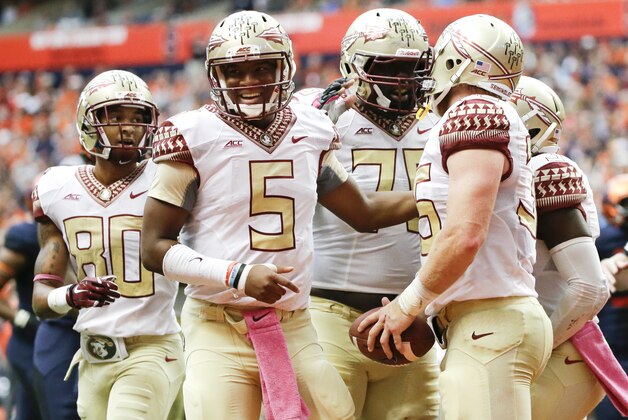 Florida State quarterback Jameis Winston (5) and Rashad Greene (80) celebrate with teammate Nick O'Leary (35) after O'Leary caught a pass for a touchdown during the first half of an NCAA college football game against Syracuse, Saturday, Oct. 11, 2014, in Syracuse, N.Y. (AP Photo/Frank Franklin II)