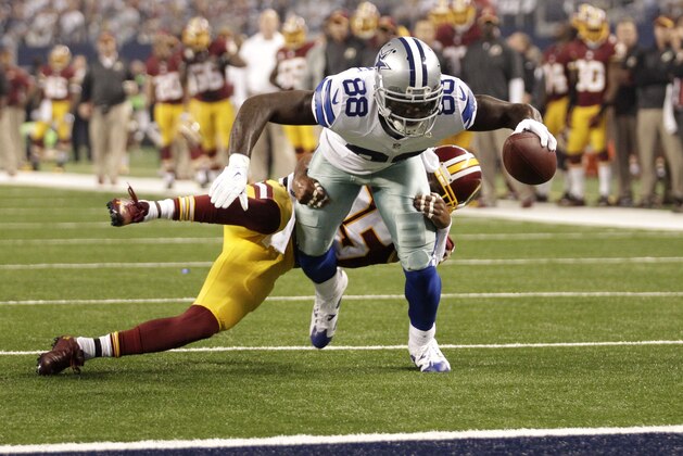 Dallas Cowboys' Dez Bryant (88) drags Washington Redskins cornerback David Amerson behind him as he prepares to score a touchdown during the first half of an NFL football game, Monday, Oct. 27, 2014, in Arlington, Texas. (AP Photo/Tim Sharp)