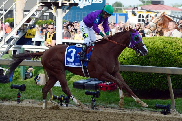 May 17, 2014; Baltimore, MD, USA; Victor Espinoza aboard California Chrome crosses the finish line to win the 139th Preakness Stakes at Pimlico Race Course. Mandatory Credit: Tommy Gilligan-USA TODAY Sports