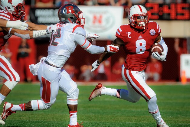 LINCOLN, NE - OCTOBER 25: Running back Ameer Abdullah #8 of the Nebraska Cornhuskers runs past defensive back Nadir Barnwell #12 of the Rutgers Scarlet Knights during their game at Memorial Stadium on October 25, 2014 in Lincoln, Nebraska.  (Photo by Eric Francis/Getty Images)