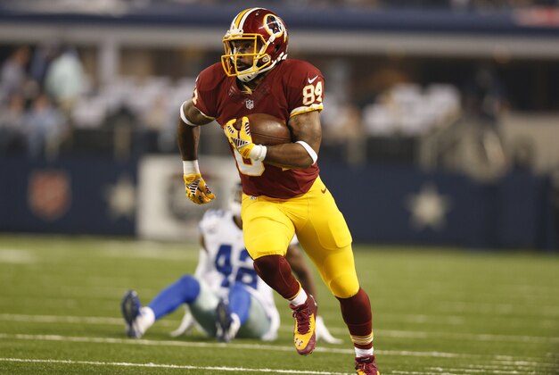 Oct 27, 2014; Arlington, TX, USA; Washington Redskins tight end Niles Paul (84) runs after a reception against Dallas Cowboys safety Barry Church (42) in the first quarter at AT&T Stadium. Mandatory Credit: Matthew Emmons-USA TODAY Sports