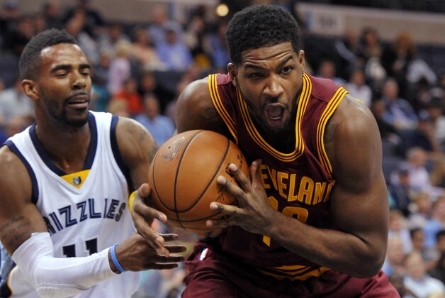 Cleveland Cavaliers forward Tristan Thompson, right, drives past Memphis Grizzlies guard Mike Conley (11) in the first half of a preseason NBA basketball game Wednesday, Oct. 22, 2014, in Memphis, Tenn. (AP Photo/Brandon Dill)