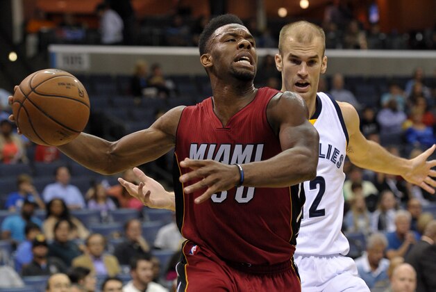 Miami Heat guard Norris Cole, front, drives past Memphis Grizzlies guard Nick Calathes in the first half of a preseason NBA basketball game Friday, Oct. 24, 2014, in Memphis, Tenn. (AP Photo/Brandon Dill)