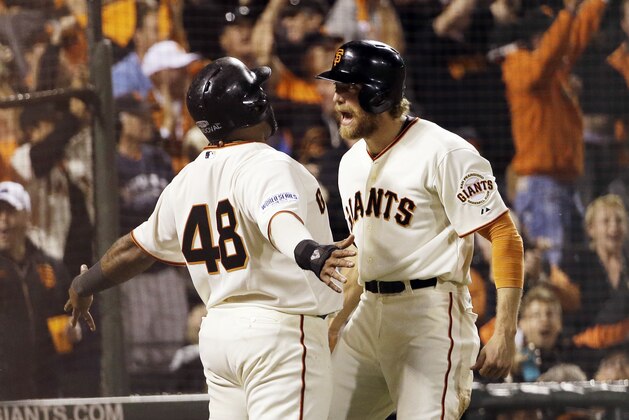 San Francisco Giants' Pablo Sandoval (48) and Hunter Pence celebrate after scoring on a double by Juan Perez during the eighth inning of Game 5 of baseball's World Series against the Kansas City Royals Sunday, Oct. 26, 2014, in San Francisco. (AP Photo/David J. Phillip)