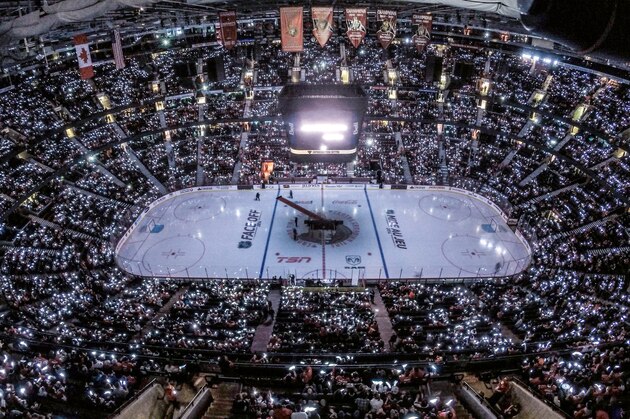 OTTAWA, ON - OCTOBER 25: In a coordinated tribute with NHL games in Montreal and Toronto to honor Canadian soldiers who lost their lives this past week, fans wave glow sticks prior to a game between the Ottawa Senators and the New Jersey Devils at Canadian Tire Centre on October 25, 2014 in Ottawa, Ontario, Canada.  (Photo by Andre Ringuette/NHLI via Getty Images)