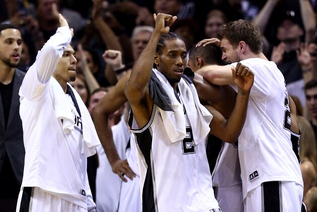 SAN ANTONIO, TX - JUNE 15: Kawhi Leonard #2 of the San Antonio Spurs celebrates on the bench against the Miami Heat during Game Five of the 2014 NBA Finals at the AT&T Center on June 15, 2014 in San Antonio, Texas. NOTE TO USER: User expressly acknowledges and agrees that, by downloading and or using this photograph, User is consenting to the terms and conditions of the Getty Images License Agreement.  (Photo by Andy Lyons/Getty Images)