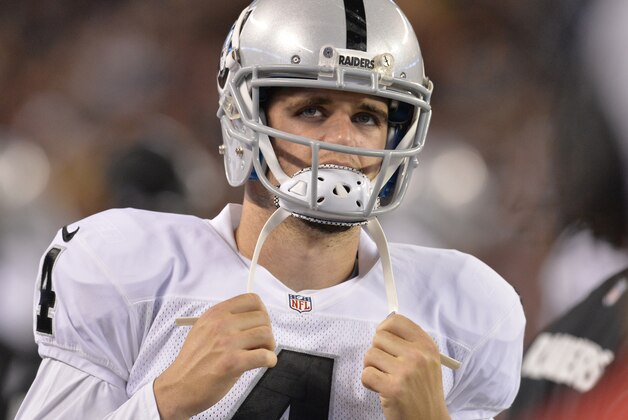 Oakland Raiders quarterback Derek Carr watches from the sidelines in the fourth quarter of anagainst the Cleveland Browns  NFL football game Sunday, Oct. 26, 2014, in Cleveland. (AP Photo/David Richard)